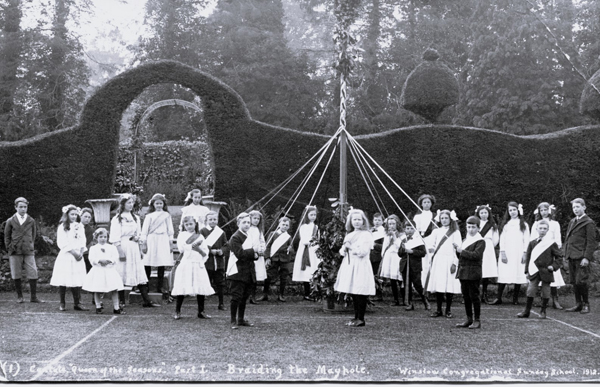 Children with maypole performing Queen of the Seaons outdoors